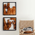 Design reference: Pair of black-framed wood wall sculptures beside a woven chair.