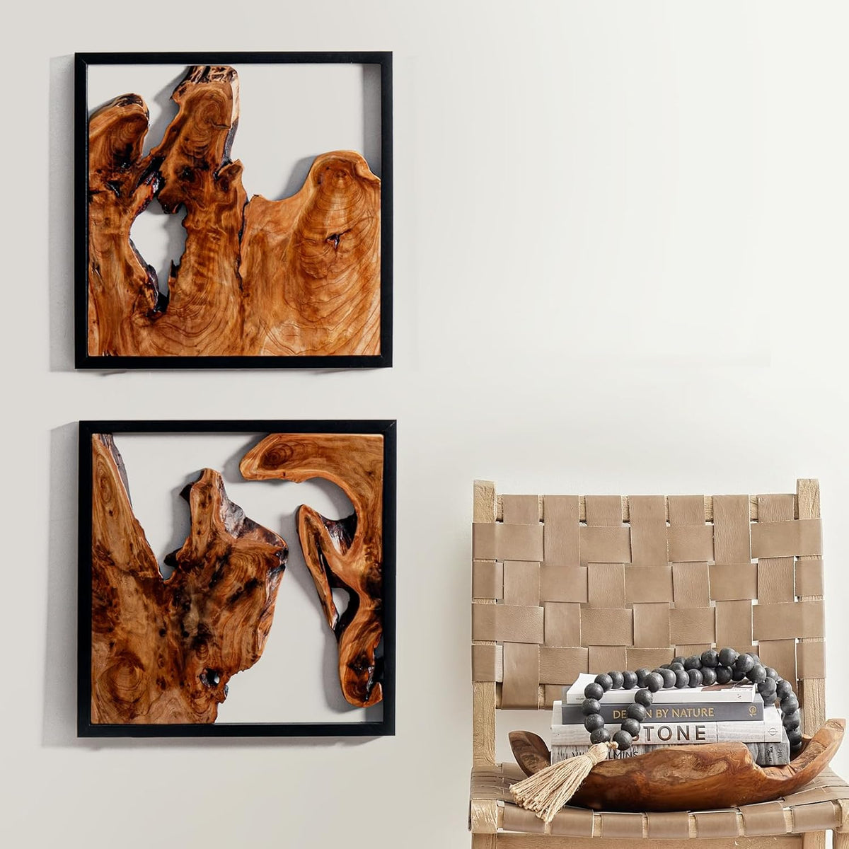 Design reference: Pair of black-framed wood wall sculptures beside a woven chair.