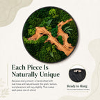 A circular wall art piece featuring preserved green moss and a central piece of light brown natural wood. The artwork is encased in a thin black frame. Text on the image reads: Each Piece Is Naturally Unique, Ready to Hang.