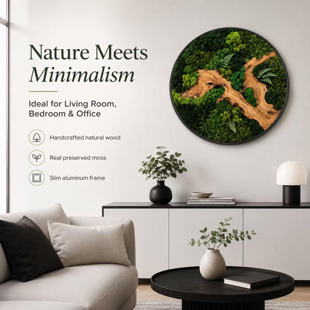 A circular wall art piece featuring preserved green moss and a light brown wooden branch element encased in a slim black aluminum frame. The text on the wall reads Nature Meets Minimalism, Ideal for Living Room, Bedroom & Office.