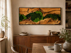 A rectangular wall art piece featuring a natural wood frame with a central horizontal gap filled with vibrant green preserved moss. The wood displays a rich, textured grain pattern with deep brown tones and organic, weathered edges.