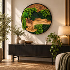 A circular wall art piece featuring a natural wood slice centerpiece surrounded by vibrant green preserved moss and fern foliage, all encased within a thin black frame. The composition displays varied textures of moss and wood.