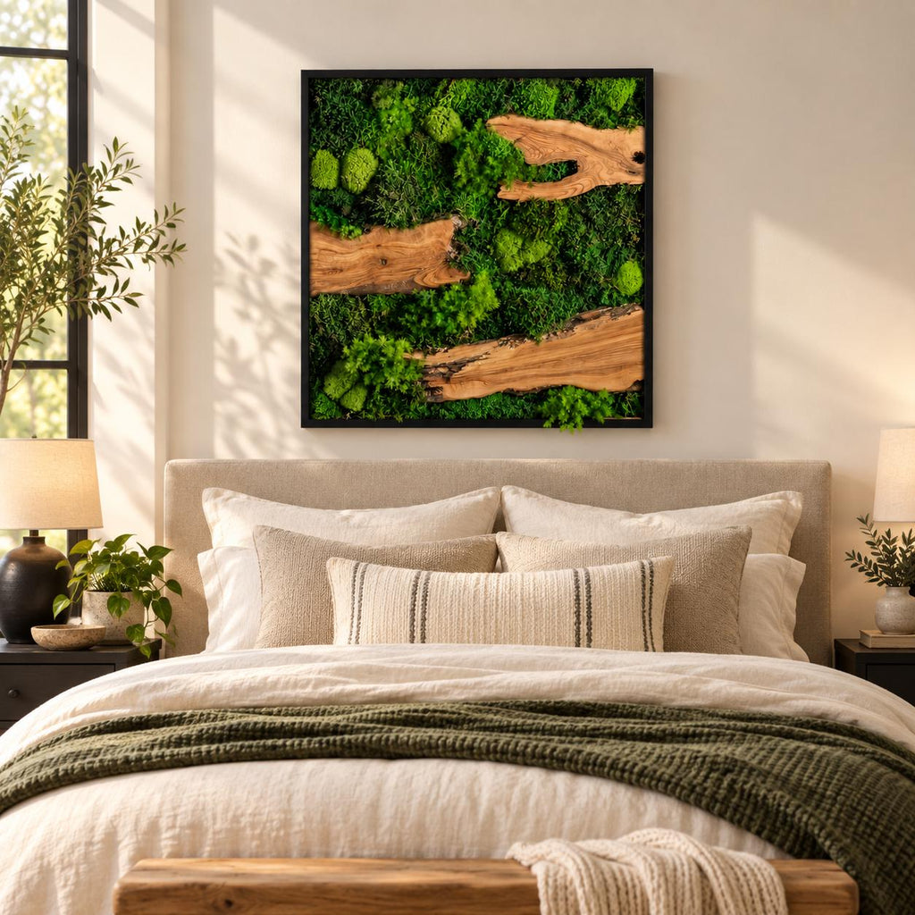 A square wall art piece featuring a black frame filled with preserved green moss and three horizontal pieces of natural light brown wood. The moss displays various textures and shades of green, creating a dense, layered appearance.