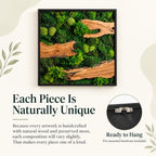 A square wall art piece featuring preserved green moss and natural wood segments encased in a black frame. The text reads: Each Piece Is Naturally Unique. Because every artwork is handcrafted with natural wood and preserved moss, each composition will vary slightly. That makes every piece one of a kind. Ready to Hang. Pre-mounted hardware included.