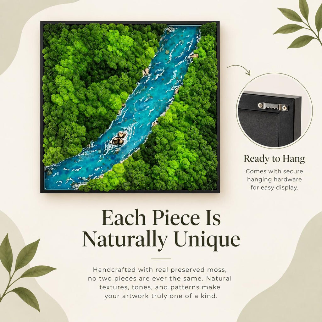 A square wall art piece featuring a preserved moss forest landscape with a central blue river. The artwork is encased in a black frame and includes a metal sawtooth hanger on the back for mounting. The scene depicts dense green foliage.