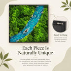A square wall art piece featuring a preserved moss forest landscape with a central blue river. The artwork is encased in a black frame and includes a metal sawtooth hanger on the back for mounting. The scene depicts dense green foliage.