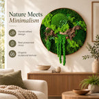 A circular wall art piece featuring preserved green moss and a piece of driftwood. The text on the left reads Nature Meets Minimalism, Handcrafted design, Real preserved moss, and Organic sculptural texture. The art is mounted on a wall.