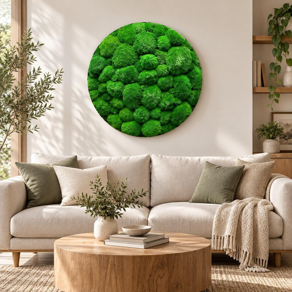 A circular wall art piece featuring a dense, textured arrangement of vibrant green preserved moss. The artwork consists of numerous rounded, clumped moss formations in varying shades of bright and deep forest green, creating a relief.