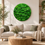 A circular wall art piece featuring a dense, textured arrangement of vibrant green preserved moss. The artwork consists of numerous rounded, clumped moss formations in varying shades of bright and deep forest green, creating a relief.