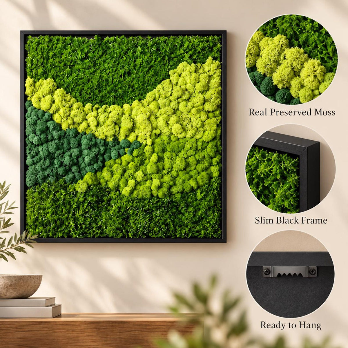 A square wall art piece featuring preserved moss in varying shades of green, including bright lime and deep forest tones. The moss is encased in a slim black frame. The back includes a metal sawtooth hanger for wall mounting.