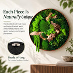 A circular wall art piece featuring preserved green moss and natural brown wood branches encased in a thin copper-toned frame. The text reads: Each Piece Is Naturally Unique, Handcrafted with real moss and natural wood, and Ready to Hang.