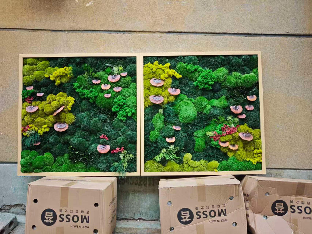 Two rectangular wall art pieces featuring preserved moss in various shades of green, including lime and forest green, accented with small pinkish-brown shelf fungi and patches of red foliage, all enclosed in light wooden frames.