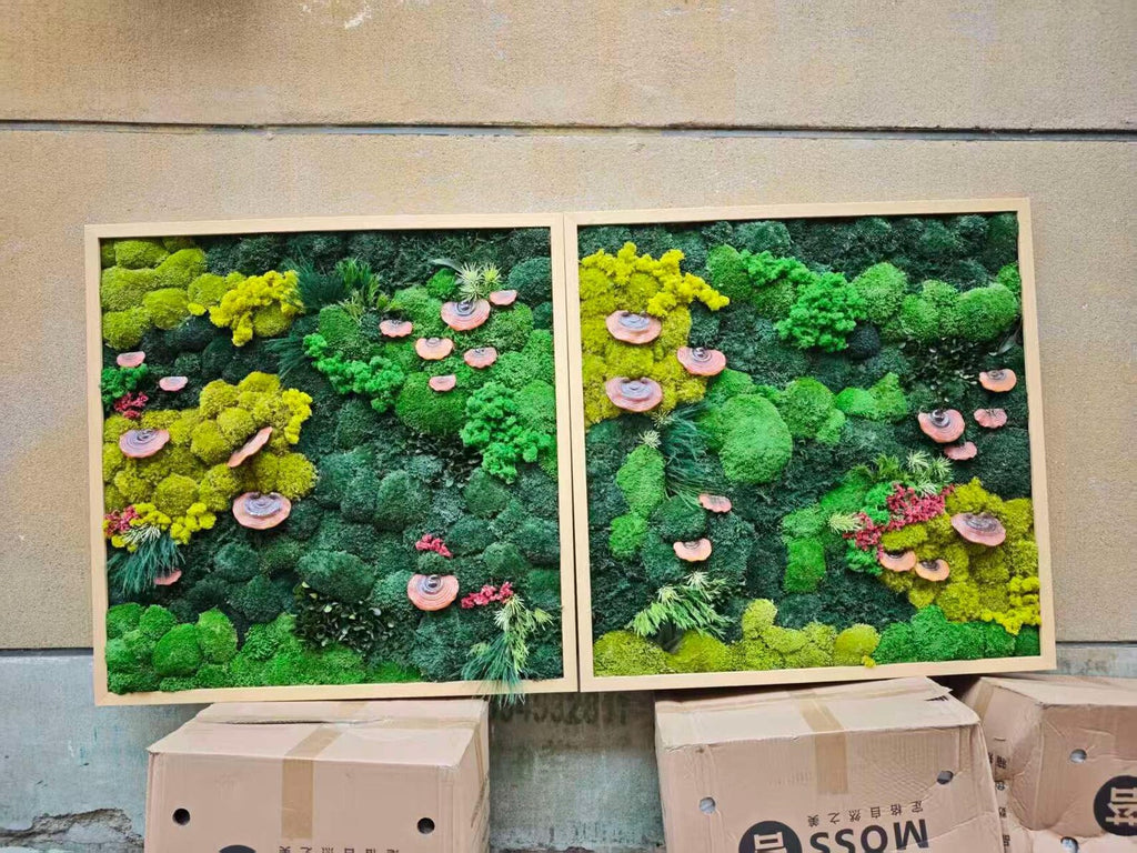 Two rectangular wall art pieces featuring preserved moss in shades of lime green, forest green, and dark emerald. The textured moss displays clusters of small, flat, circular, light brown fungi and thin green foliage within light wood frames.