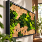 A rectangular wall art piece featuring a natural wood slab with a prominent grain and knots, accented by clusters of preserved moss in varying shades of bright lime, emerald, and dark forest green, all encased in a black frame.
